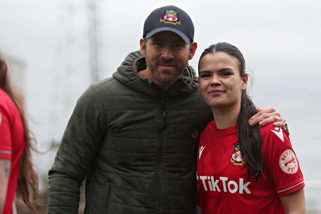 WREXHAM, WALES - 26th MARCH 2023 - Ryan Reynolds and Wrexham's Amber Lightfoot after Wrexham AFC Women vs Connah's Quay Nomads in the final game of the Genero Adran North at The Racecourse Ground, Wrexham