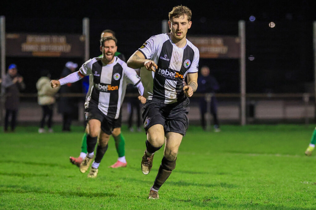 AMMANFORD, WALES -  24 February 2026 : Matthew Delaney of Ammanford AFC celebrates after scoring during the 2025/26 JD Cymru South league fixture between Ammanford AFC & Aberystwyth Town FC at Ammanford Recreation Ground, Ammanford, Wales.  (Pic by Geraint Nicholas/FAW)