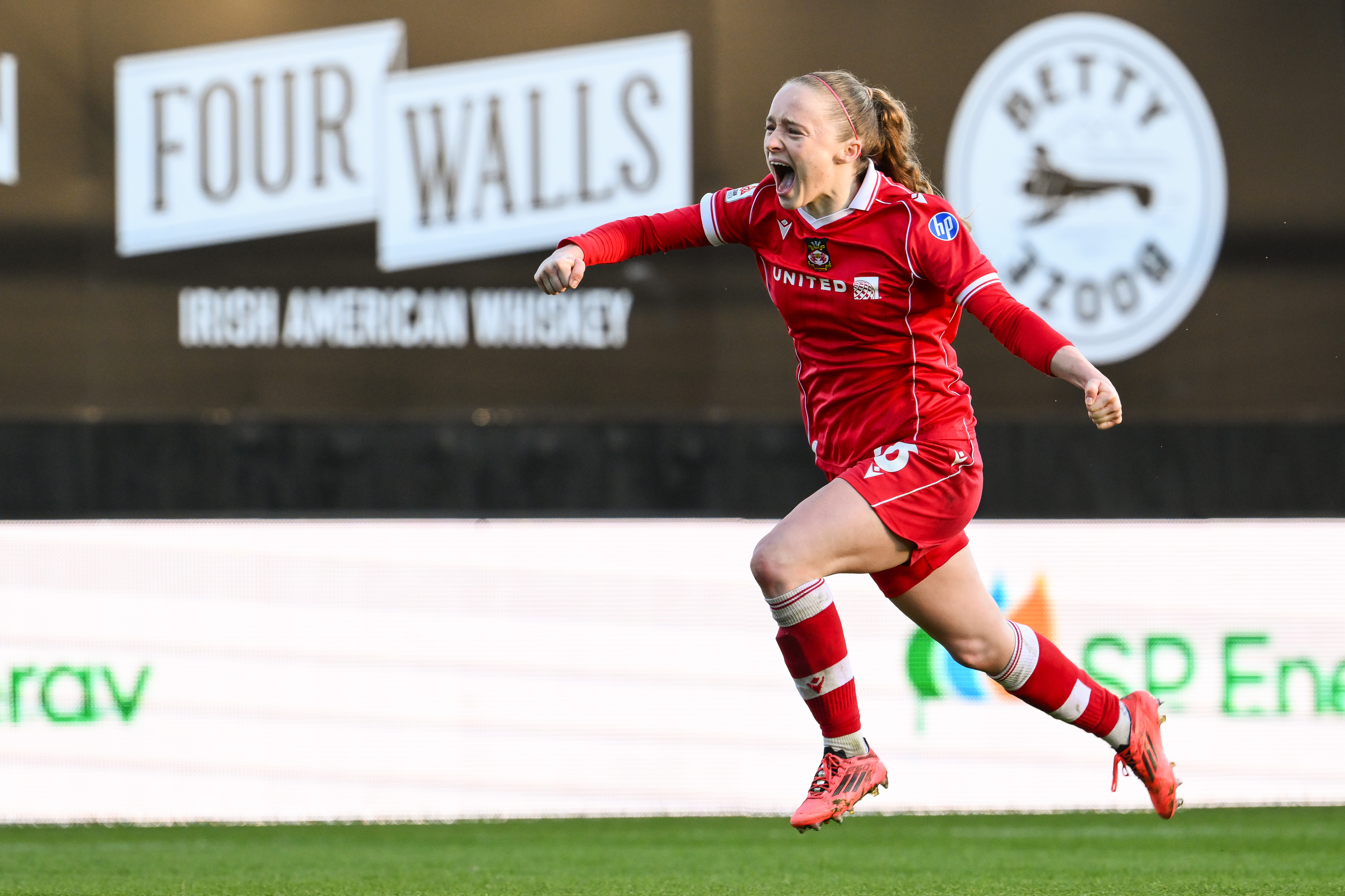 WREXHAM, WALES - 29 MARCH 2026: Katie Barker of Wrexham celebrates her goal to make it 4-1 during the Genero Adran Premier game between Wrexham and Cardiff City at the Park Hall Stadium in Oswestry