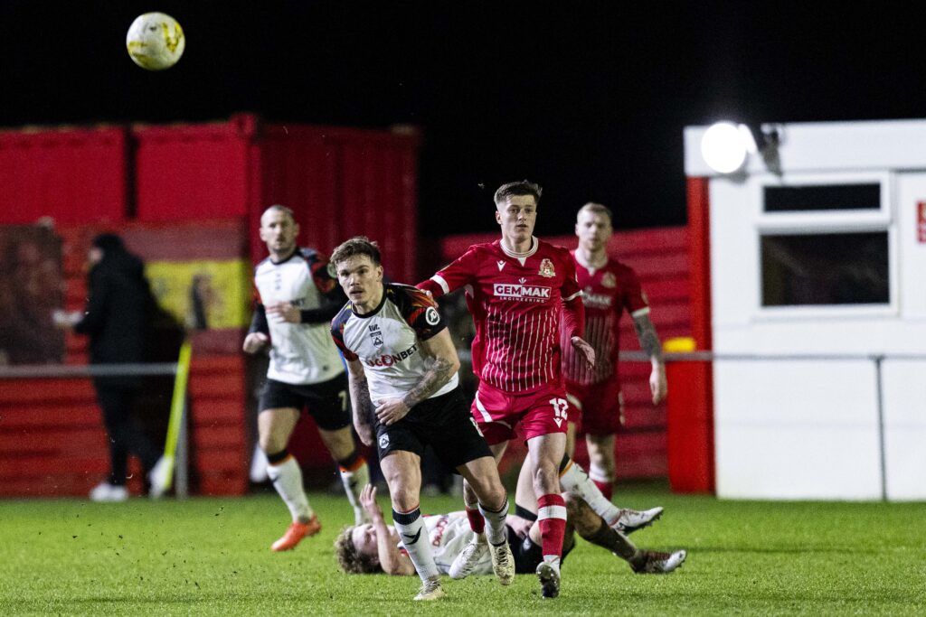 Corey Shephard of Haverfordwest County in action against Ricky-Lee Owen of Briton Ferry Llansawel. Briton Ferry Llansawel v Haverfordwest County in the JD Cymru Premier at Old Road on the 6th February 2026. (Pic by Lewis Mitchell/FAW)