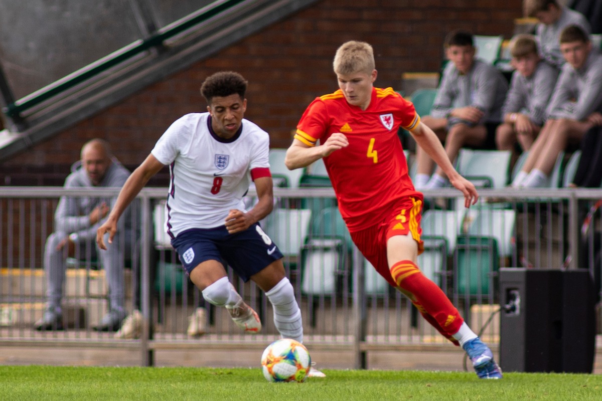 Newport, WALES - 3 September, 2021: Jordan James of Wales u18 in action against former Newcastle United and Spurs defender Jordan Hackett of England u18. Wales u18 v England u18 friendly at Spytty Park on the 3rd September 2021