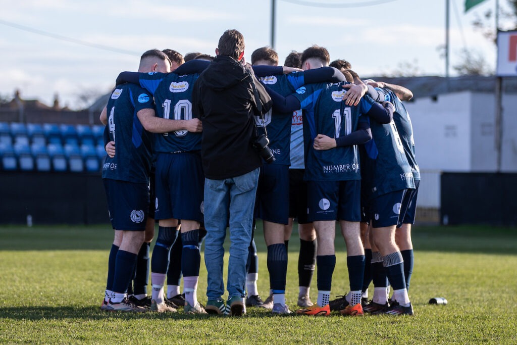 RHYL, WALES - 22ND NOVEMBER 2025: Ardal Leagues South east Cwmbran Town team huddle ahead of the JD Welsh Cup fixture between CPD Y Rhyl 1879 and Cwmbran Town at the Hops and Barley Stadium, Rhyl. 22nd of November, Rhyl, Wales