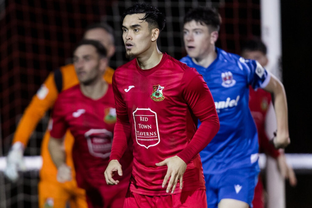 Miles John of Llanelli Town in action during an FAW Welsh Cup match against Penybont at Stebonheath Park.