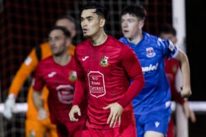 Miles John of Llanelli Town in action during an FAW Welsh Cup match against Penybont at Stebonheath Park.