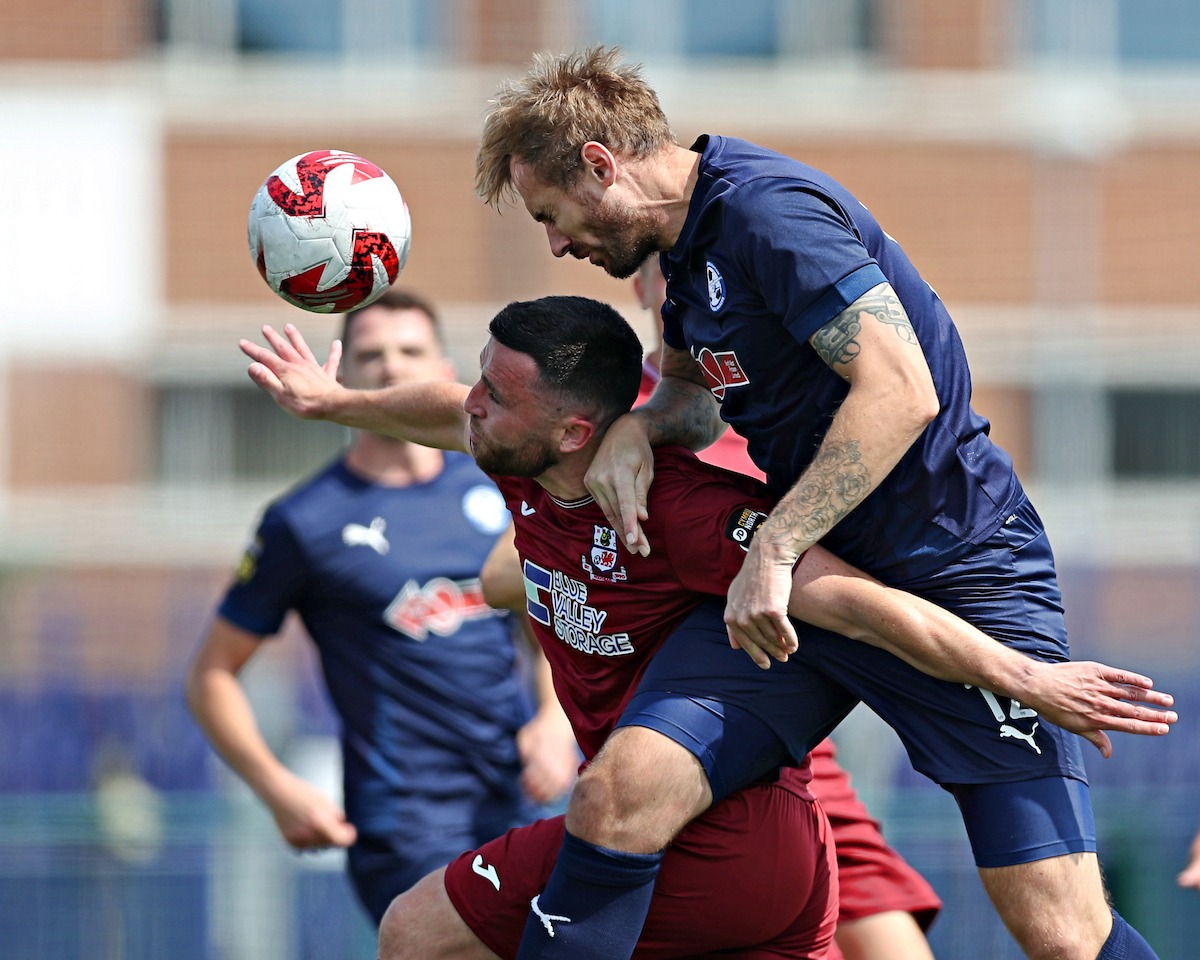 BROUGHTON, FLINTSHIRE, WALES - 9th AUGUST 2025 - Blaine Hudson of Airbus UK Broughton battles with Nathan Williams of Holyhead Hotspur during Airbus UK Broughton vs Holyhead Hotspur in Round 2 of the JD Cymru North at the Hollingsworth Group Stadium, Broughton