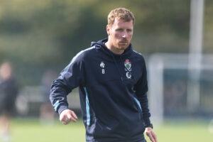 Newtown manager Jay Owen warming up for Colwyn Bay