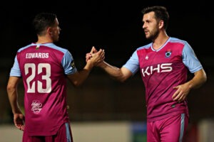 FLINT, FLINTSHIRE, WALES - 7th OCTOBER 2025 - Aeron Edwards of Colwyn Bay F.C. and Aaron Williams of Colwyn Bay FC after Flint Town United vs Colwyn Bay FC in Round 12 of the JD Cymru Premier at Cae Y Castell, Flint