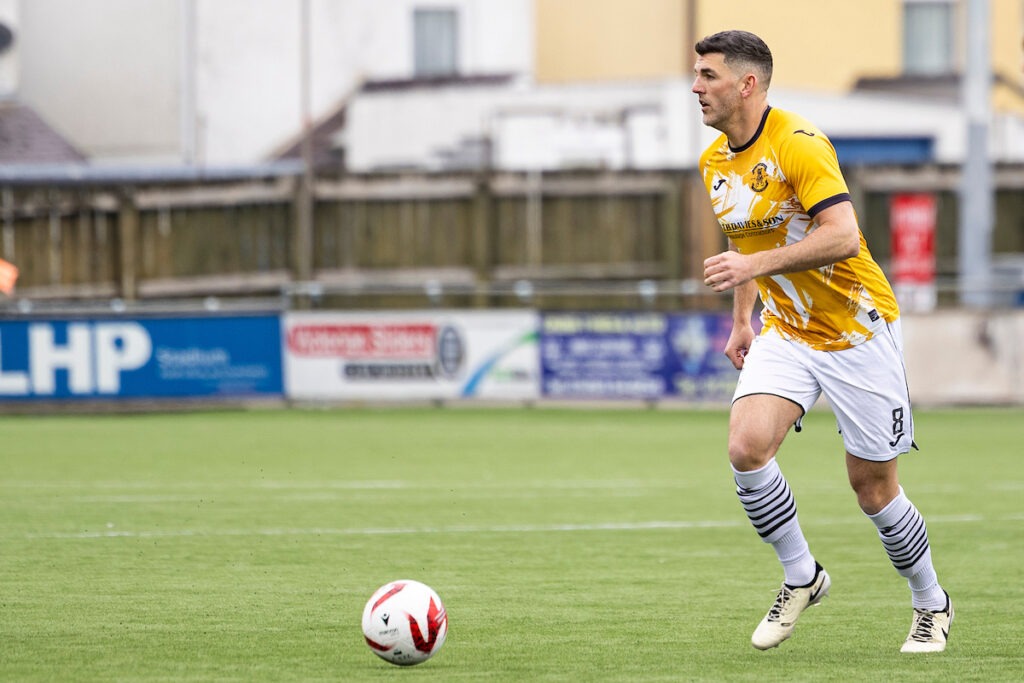 Liam Reed of Carmarthen Town dribbles the ball during a JD Cymru South match against Penrhiwceiber Rangers at Richmond Park.