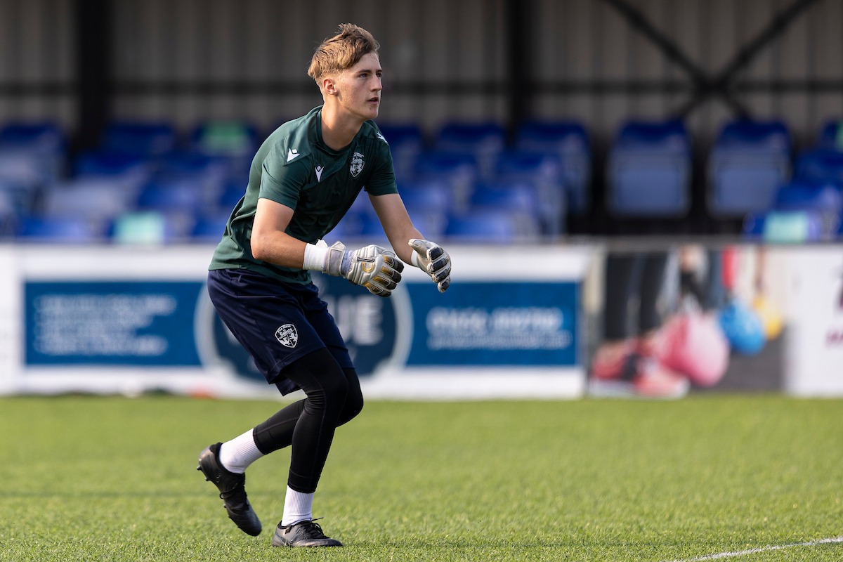 The New Saints goalkeeper Bryn Owen dives to make a save during warm-up ahead of a Cymru Premier match against Penybont.
