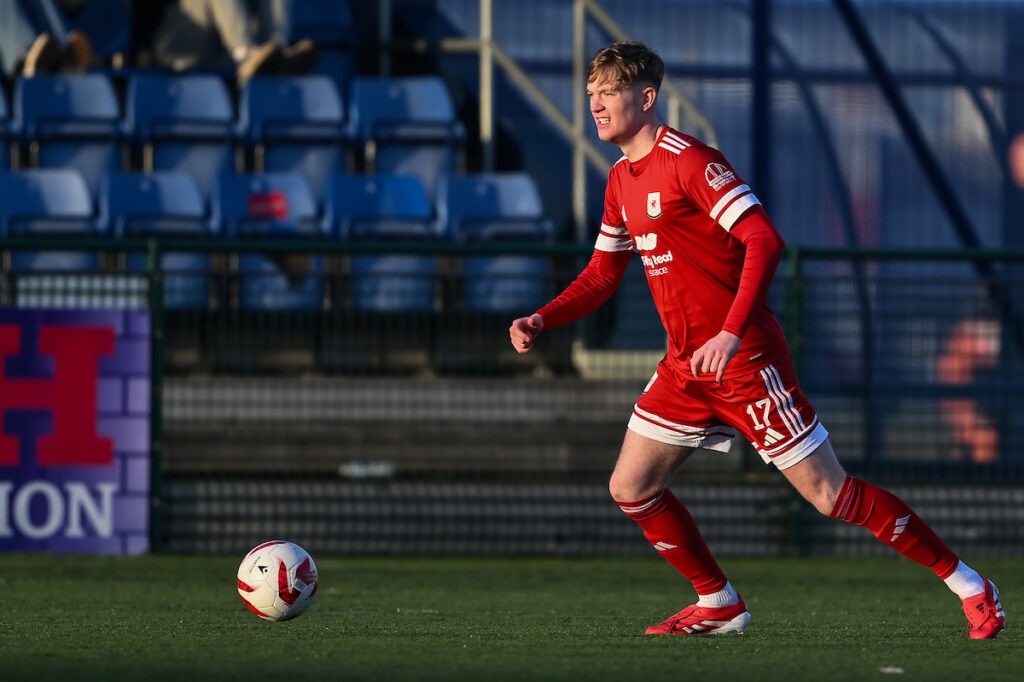 Billy Nicholas of Gresford Athletic dribbles the ball forward during a Cymru North match against Penrhyncoch.
