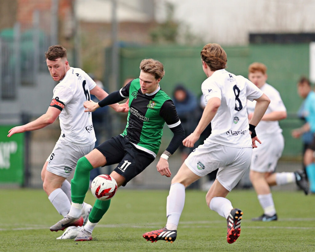 Tom McLean of Caerau Ely AFC pressures Piers Juliff of Aberystwyth Town during Aberystwyth Town vs Caerau Ely AFC in Round 24 of the JD Cymru South at Park Avenue, Aberystwyth