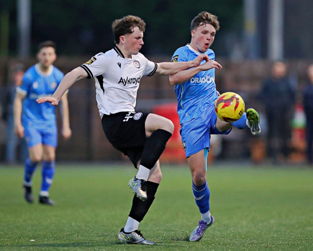 Harry Dean of Bala Town pressures Rhys Abbruzzese of Haverfordwest County during Bala Town vs Haverfordwest County in the JD Cymru Premier Play-Off Conference at Maes Tegid, 21 March 2026