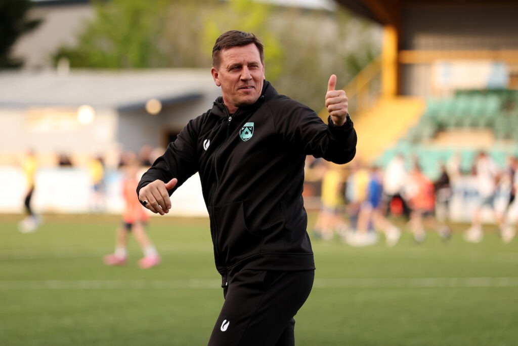 Haverfordwest County manager Tony Pennock giving a thumbs-up during a JD Cymru Premier European Play-Off match between Barry Town United and Haverfordwest County at Jenner Park Stadium in Barry, Wales, on 26 April 2026.
