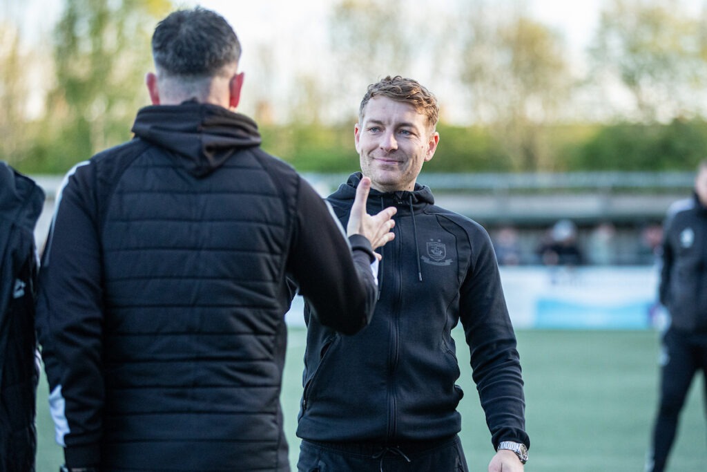 FLINT, WALES - 18TH APRIL 2026: Connah's Quay Nomads' Manager, John Disney and Colwyn Bay Manager, Mike Wilde following the JD Cymru Premier fixture between Connah’s Quay Nomads and Colwyn Bay at the Essity Stadium, Flint. 18th of April, Flint, Wales