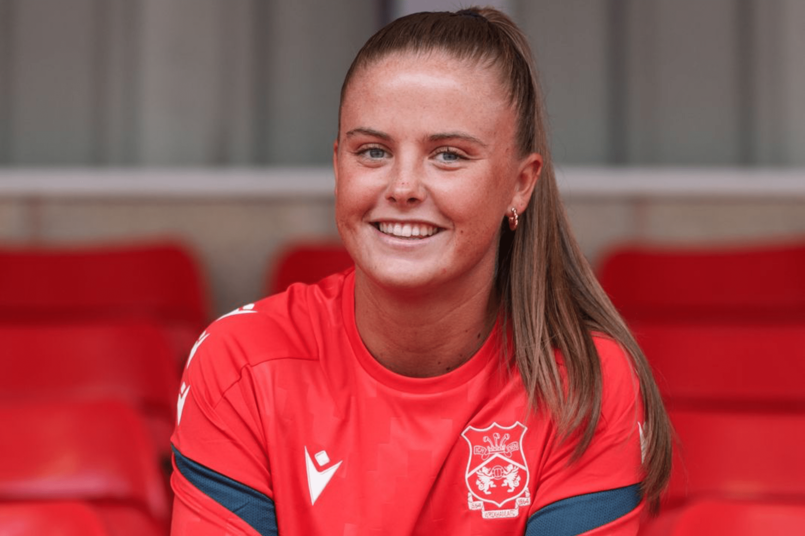 Lucy Farrell-Shrouder posing in a Wrexham kit