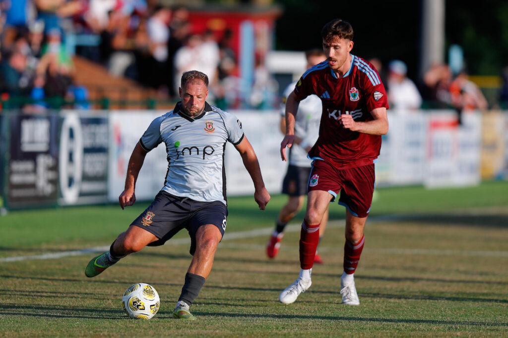 Kane Owen of Trefelin BGC and Adam Davies of Colwyn Bay during the Novira Cymru Premier game between Colwyn Bay and Trefelin BGC at The Blue Turtle Arena in Colwyn Bay