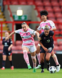 Milana Rahimova of Riga FC Women pressures Ava Suckley of Wrexham AFC Women during Riga Women FC vs Wrexham AFC Women in the Women's Champions League Qualification First Round Final at the Racecourse Ground, Wrexham