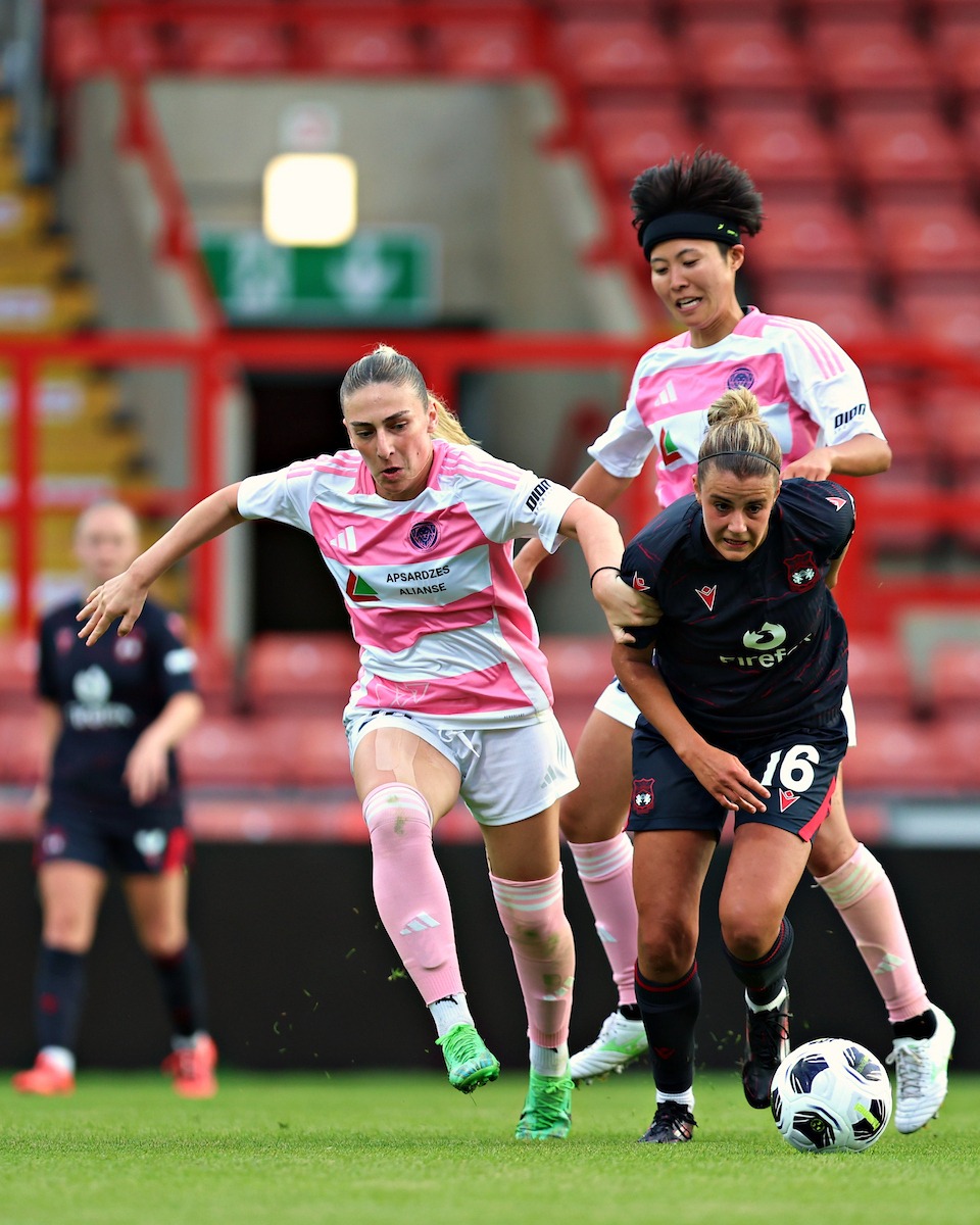 Milana Rahimova of Riga FC Women pressures Ava Suckley of Wrexham AFC Women during Riga Women FC vs Wrexham AFC Women in the Women's Champions League Qualification First Round Final at the Racecourse Ground, Wrexham