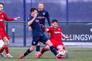 Newtown's Roberts Evans tackles Airbus' Kaiden Cooke during the WBS Blood Cup fixture between Airbus UK Broughton and Newtown at the Hollingsworth Bros Stadium, Broughton. 7th of February, Broughton, Wales
