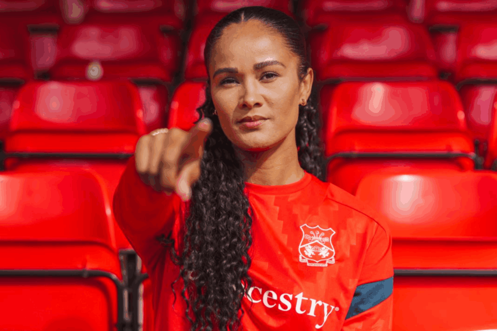 Natasha Thomas poses in a Wrexham training kit