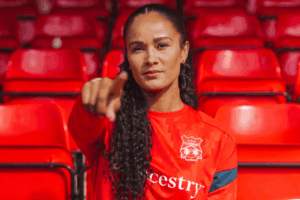 Natasha Thomas poses in a Wrexham training kit
