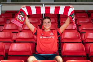 Aston Villa's Lydia Sallaway holds up a scarf as she is unveiled as a Wrexham player