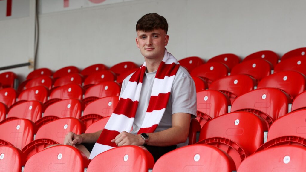 Former Crewe Alexandra striker Ffranc Vaughan-Evans poses in a Denbigh Town scarf