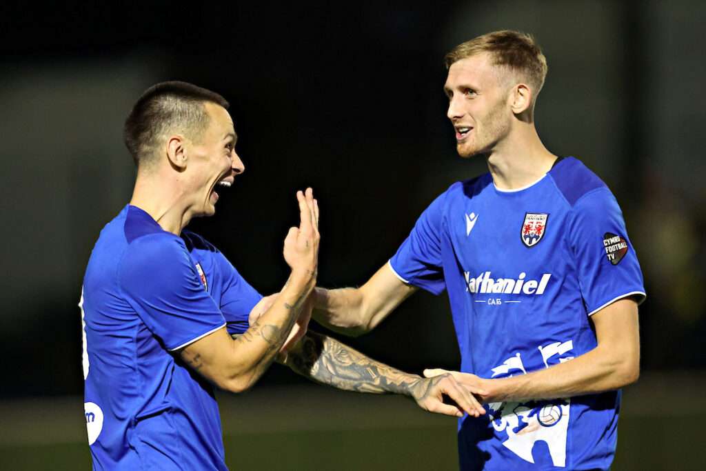 Ryan Hill of Penybont FC and Tom Mehew of Penybont FC celebrate after Caernarfon Town vs Penybont FC in Round 2 of the Novira Cymru Premier at The Oval, Caernarfon