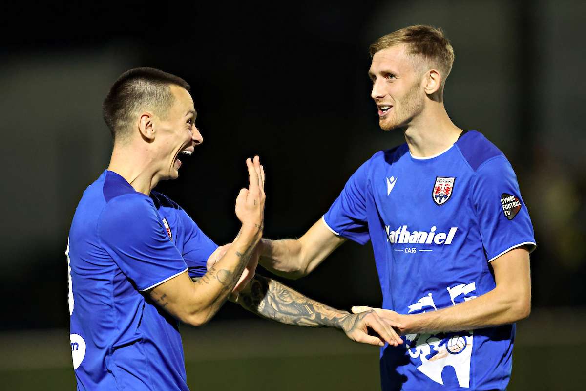 Ryan Hill of Penybont FC and Tom Mehew of Penybont FC celebrate after Caernarfon Town vs Penybont FC in Round 2 of the Novira Cymru Premier at The Oval, Caernarfon