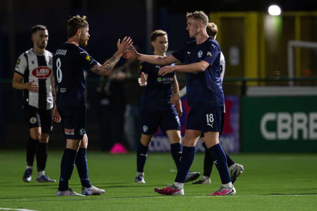 Oliver Calland and Jordan Evans of Airbus UK Broughton shake hands after their Cymru Premier match against Ammanford at The Hollingsworth Group Stadium.