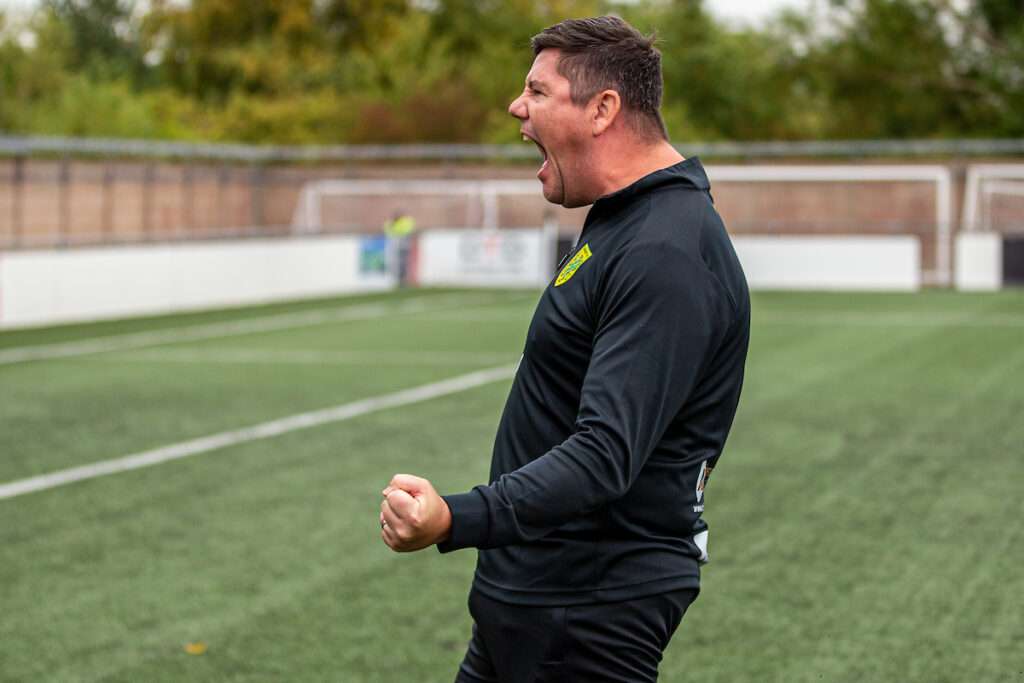 Richard Davies, Caernarfon Town manager, celebrates after the Cymru Premier match against Connah's Quay Nomads at Essity Stadium.