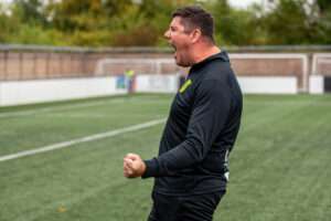 Richard Davies, Caernarfon Town manager, celebrates after the Cymru Premier match against Connah's Quay Nomads at Essity Stadium.