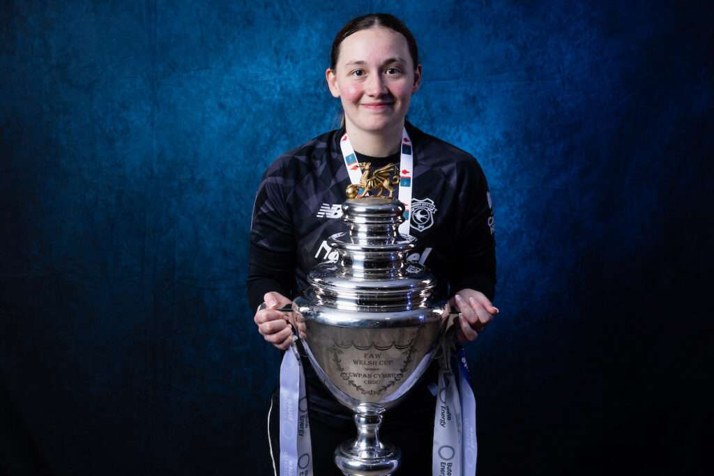 Cardiff City Womens goalkeeper Ceryn Chamberlain as Cardiff players and staff celebrate with the trophy after winning the 2025/26 Bute Energy Welsh Cup Final fixture between Cardiff City Women
