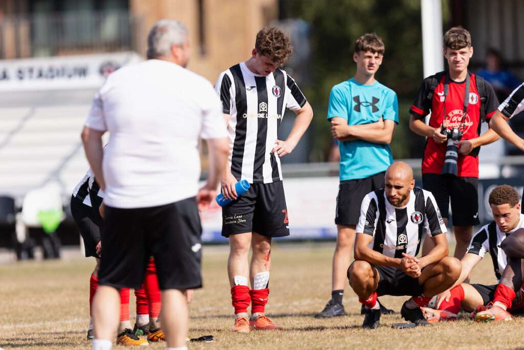 Players look dejected during the 2026/27 Novira Cymru South fixture between Cardiff Draconians FC & Pontypridd United at Lydstep Park, Cardiff, Wales