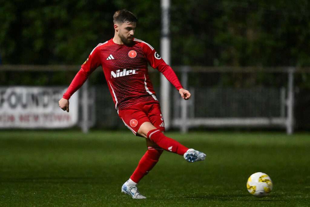 Callum Roberts of Newtown AFC passes the ball during the 2024/25 JD Cymru Premier fixture between Newtown AFC & Penybont FC at Latham Park, Newtown, Wales