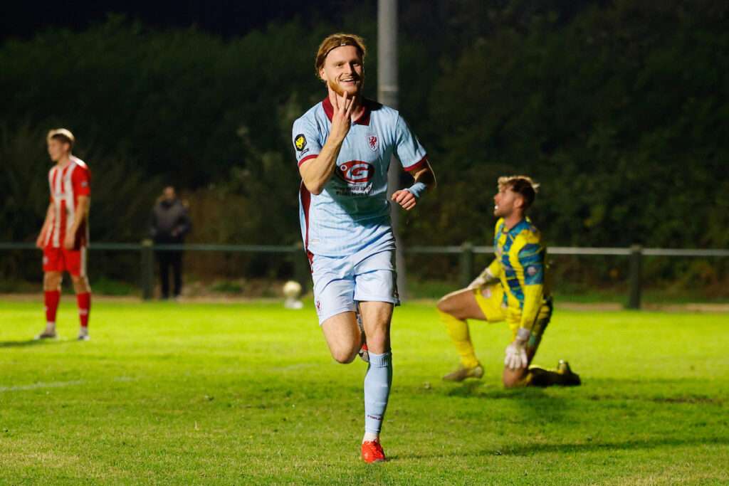 Zack Clarke of Caernarfon Town celebrates after scoring a goal to make it 2-4 and complete his hat trick during the Novira Cymru Premier game between Holywell Town and Caernarfon Town at the Barton’s North Wales Stadium in Holywell