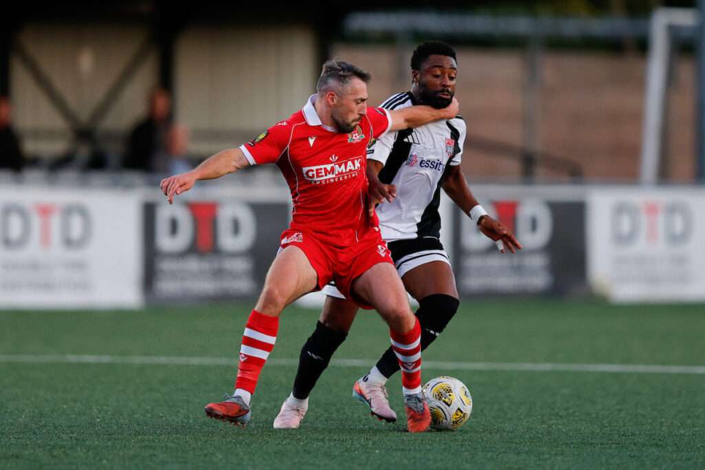 Tom Price of Briton Ferry Llansawel AFC and Tunde Owolabi of Flint Town United during the Novira Cymru Premier game between Flint Town United and Briton Ferry Llansawel AFC at the Essity Stadium in Flint