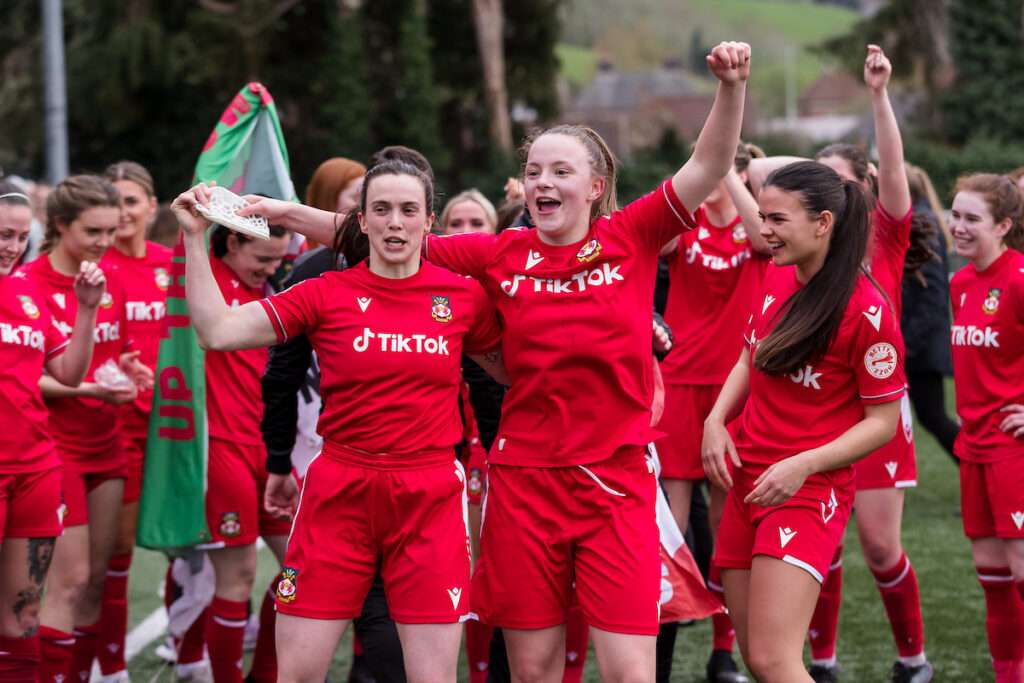 Wrexham Women's Rosie Hughes and Wrexham Women's Lili Jones during the 2022/23 Genero Adran North & South play-off fixture between Wrexham AFC Women & Briton Ferry Llansawel Ladies FC at Latham Park, Newtown, Wales, 16 April 2023