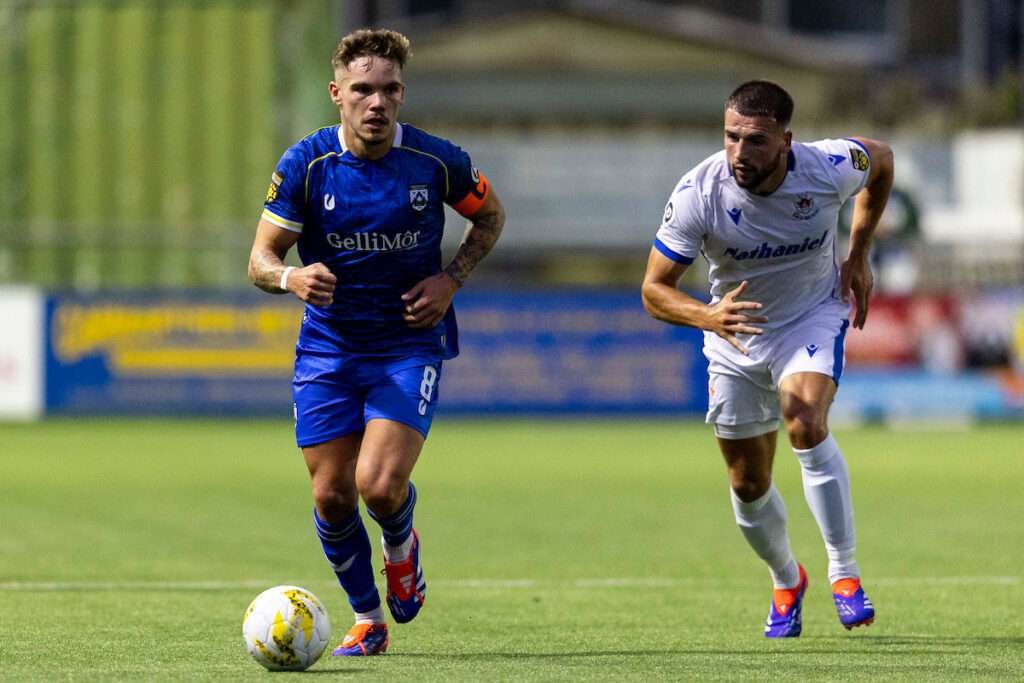 Corey Shephard of Haverfordwest County in action against Clayton Green of Penybont.
Haverfordwest County v Penybont in the JD Cymru Premier at Richmond Park on the 22nd August 2024.