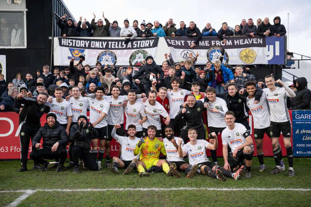 Rhyl 1879 players and staff celebrate with the fans after the final whistle of the JD Welsh Cup between Rhyl 1879 and Barry Town United at the Hops and Barley Community Stadium in Rhyl