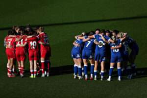 Both teams huddle before Wrexham AFC Women vs Cardiff City Women in Round 5 of the Genero Adran Premier Championship at the SToK Cae Ras, Wrexham