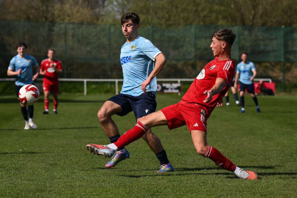 Josh Allen of Buckley Town clears the ball during the Welsh Blood Service League Cup Semi-Final between Buckley Town and Treowen Stars AFC at the Globe in Buckley