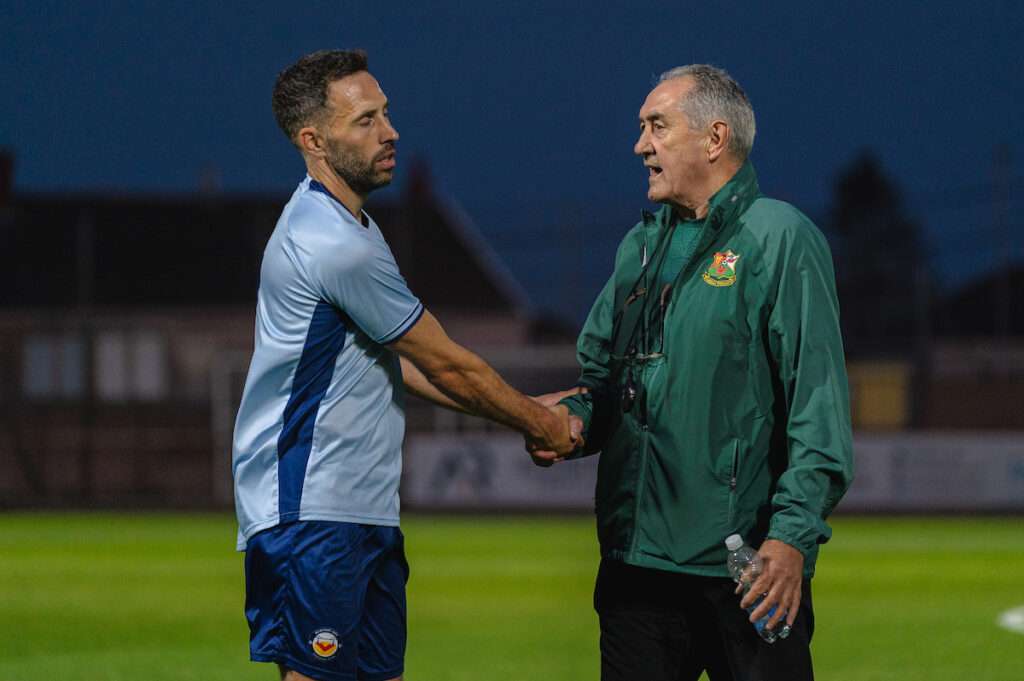 Llanelli Town Manager Terry Boyle and Newport City Manager Robbie Willmot during the Novira Cymru South fixture Llanelli Town vs Newport City at Stebonheath Park, Llanelli, Wales