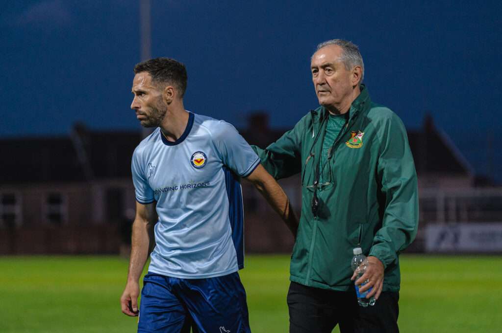 Llanelli Town Manager Terry Boyle and Newport City Manager Robbie Willmot during the Novira Cymru South fixture Llanelli Town vs Newport City at Stebonheath Park, Llanelli, Wales