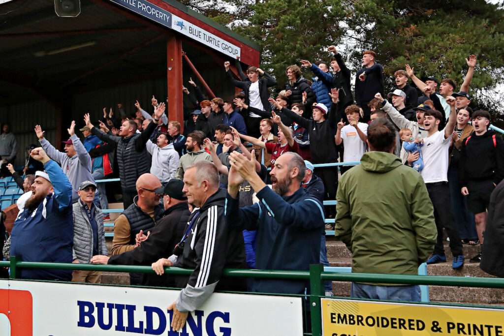 Colwyn Bay fans celebrate after Colwyn Bay FC vs Llandudno FC in Round 6 of the Novira Cymru Premier at the Blue Turtle Arena, Colwyn Bay