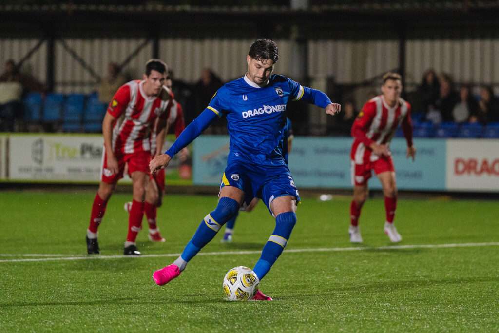 Haverfordwest County's Ben Ahmun puts the home side ahead from the penalty spot during the Novira Cymru Premier 2026/27 fixture Haverfordwest County vs Hollywell Town at Dynamite Bridge Meadow Stadium, Haverfordwest, Wales