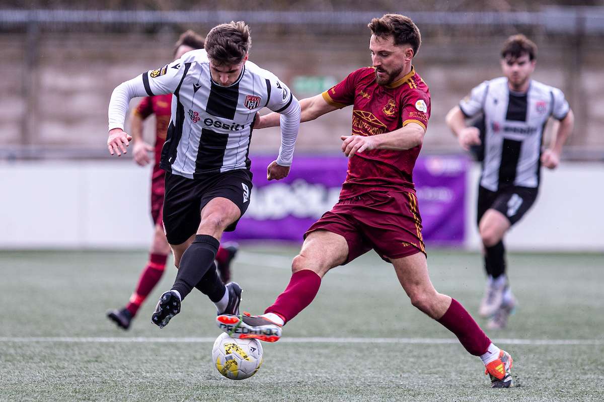 Trearddur Bay's Ryan Pryce tackles Flint Town United's Elliott Reeves during the JD Welsh Cup fixture between Flint Town United and Trearddur Bay at the Essity Stadium, Flint. 31st of January, Flint, Wales
