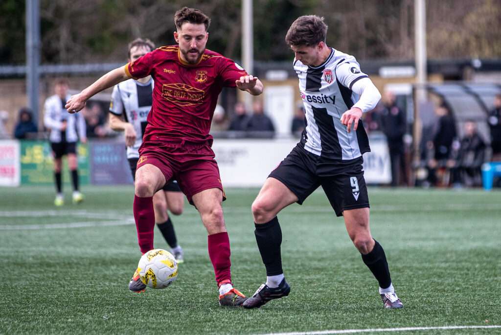 Trearddur Bay's Ryan Pryce and Flint Town United's Elliott Reeves battle for the ball during the JD Welsh Cup fixture between Flint Town United and Trearddur Bay at the Essity Stadium, Flint. 31st of January, Flint, Wales 