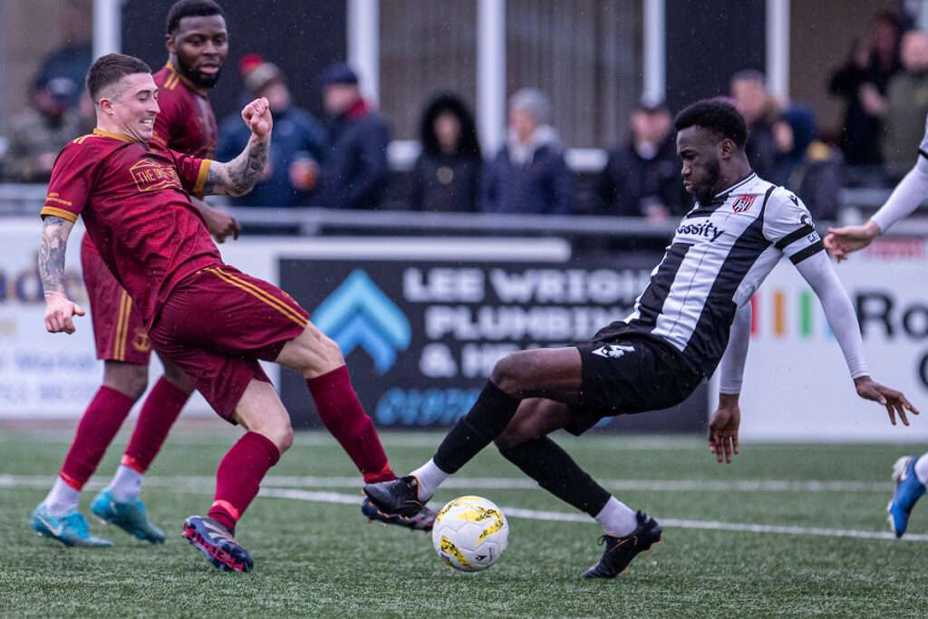 Trearddur Bay's Sean McCaffery and Flint Town United's Sidi Sanogo Fofana battle for the ball during the JD Welsh Cup fixture between Flint Town United and Trearddur Bay at the Essity Stadium, Flint. 31st of January, Flint, Wales (Pic by Nik 