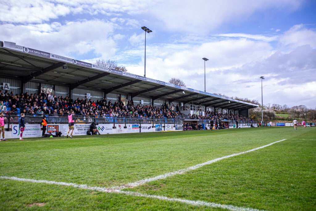 Fans during the JD Cymru Premier fixture between Colwyn Bay and Caernarfon Town at the Blue Turtle Arena, Colwyn Bay. 3rd of April, Colwyn Bay, Wales